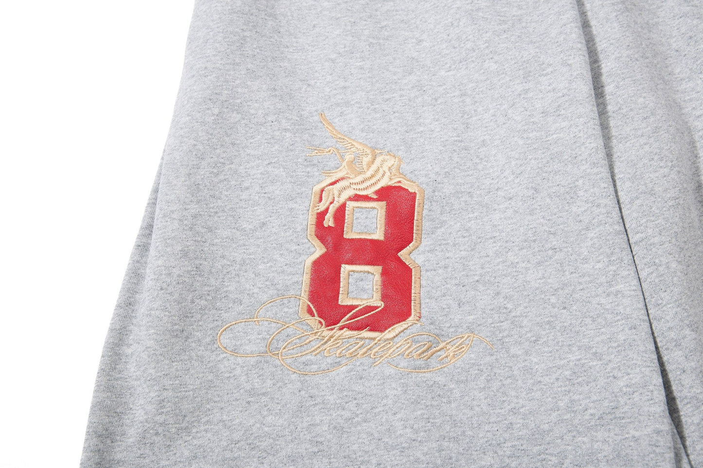 CapCabin “Varsity Crest Wide-Leg Sweatpants”